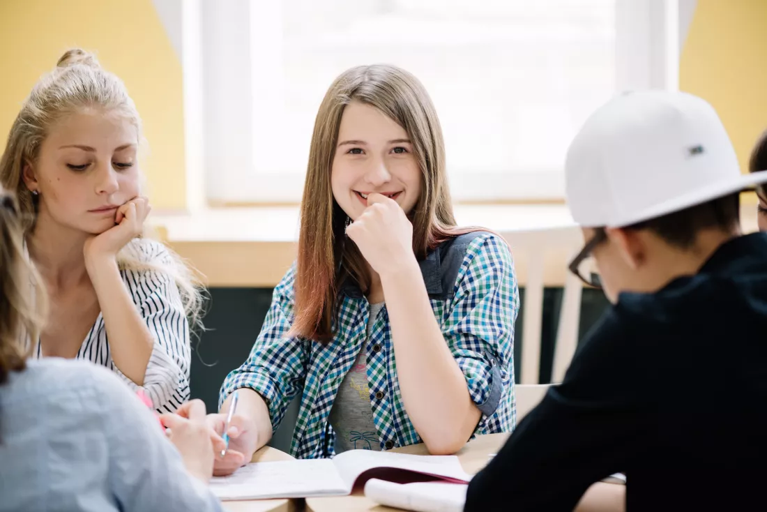 smiling-schoolgirl-with-classmates