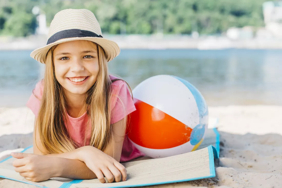 cute-girl-with-ball-smiling-coast